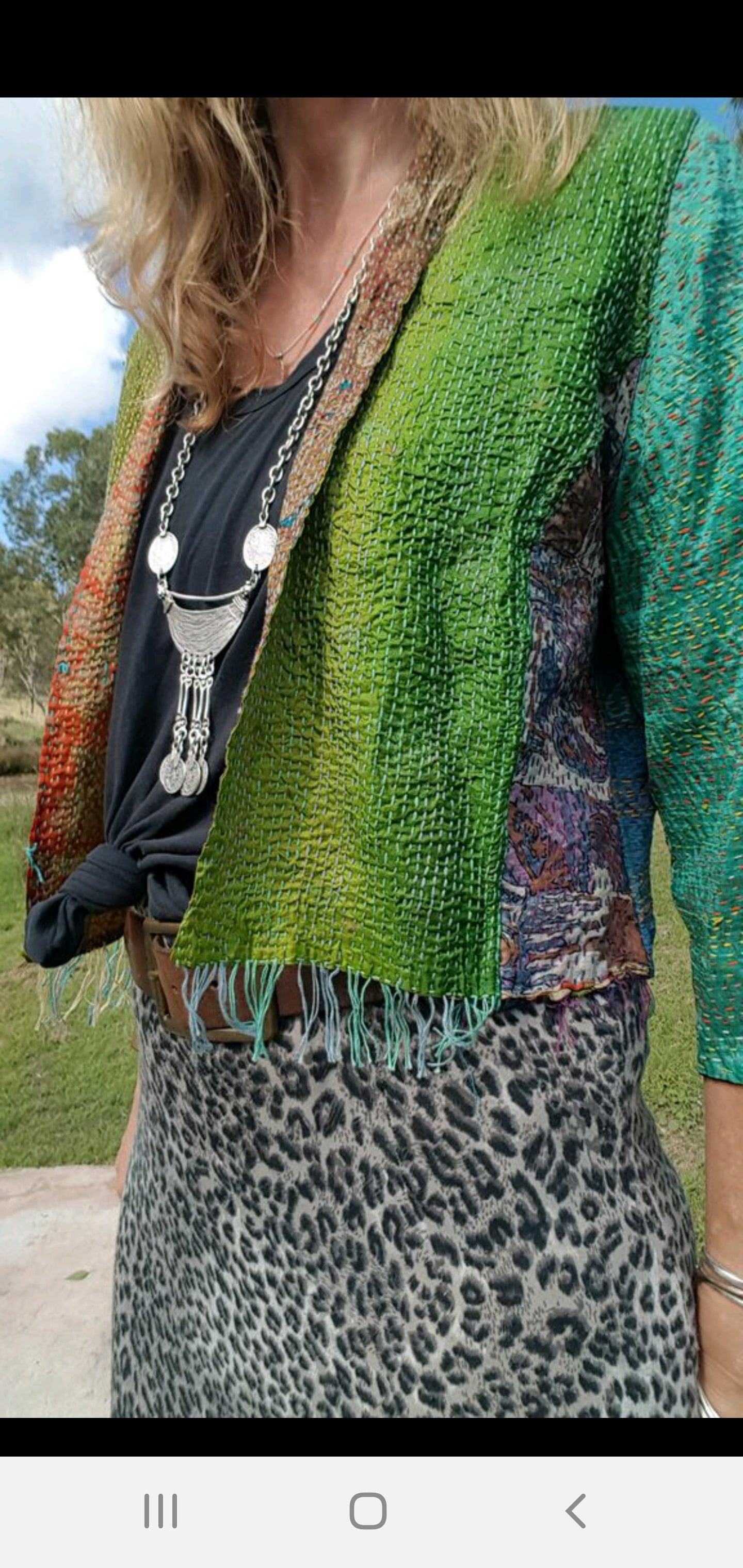 Lady wearing bohemian outfit with silver coin necklace