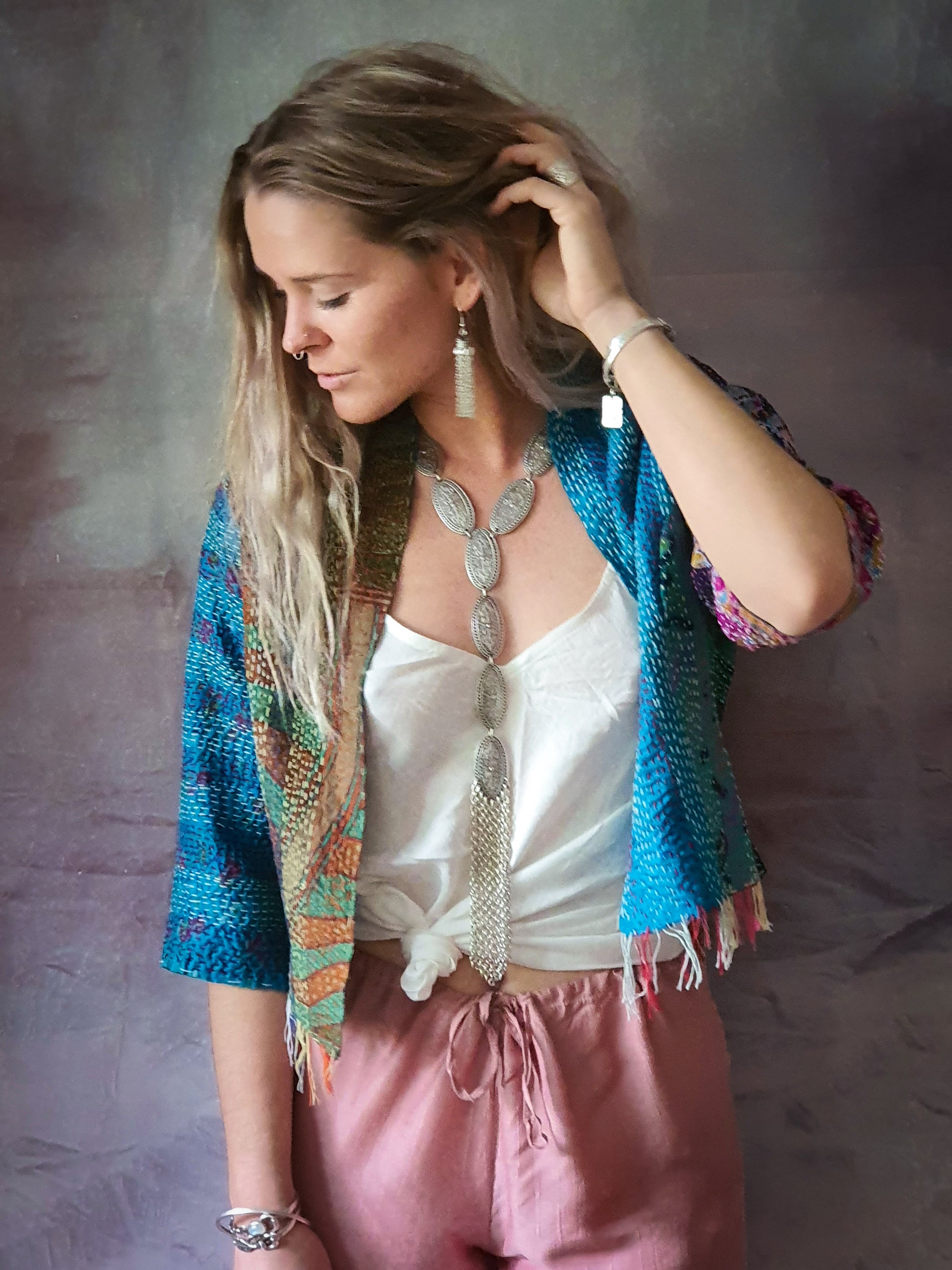 Woman wearing silver tassel necklace