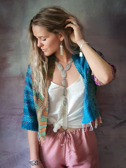 Woman wearing silver tassel necklace