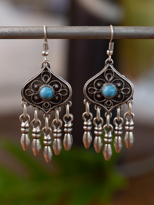 Dangly silver earrings with a blue stone