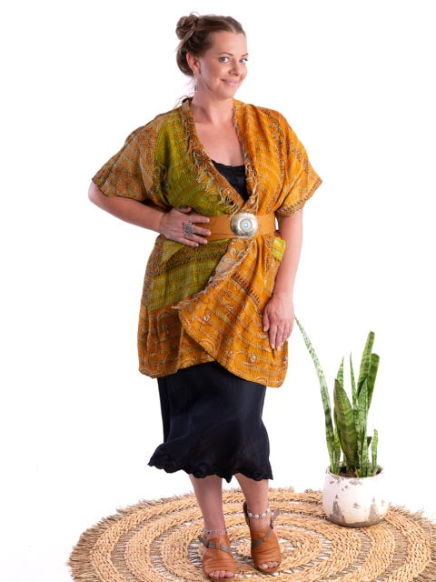 Woman wearing a indigo silk slip, mustard silk kimono and leather belt