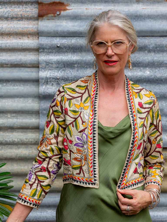 woman wearing silk jacket with vines embroidered