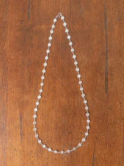 Silver Necklace - a long chain necklace with a multitude of small silver discs. Hook and clasp closure.