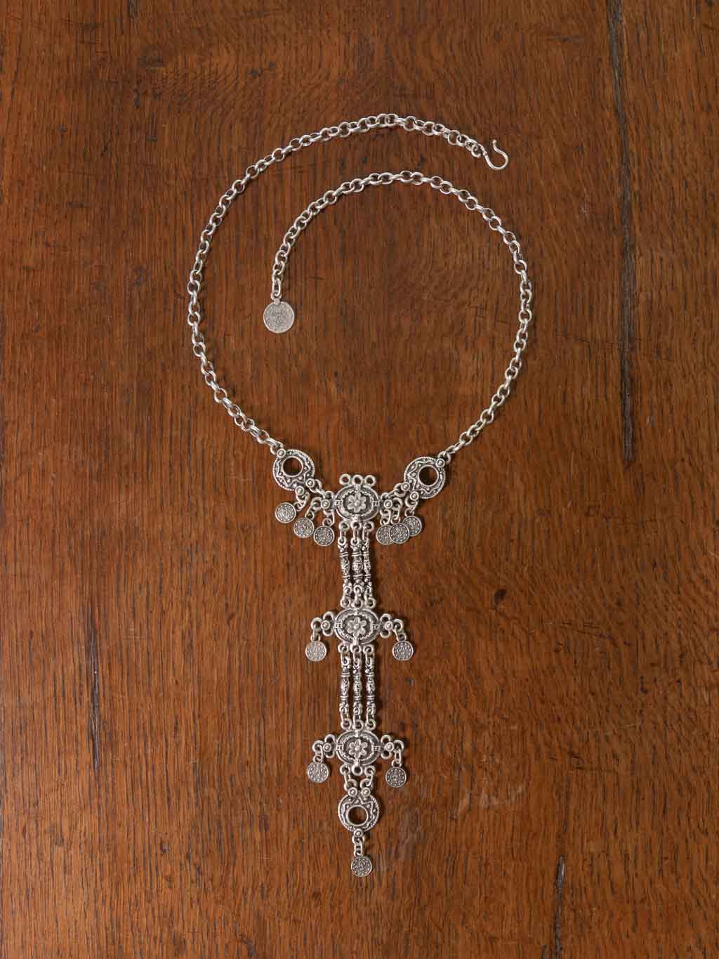 Fina Necklace - a long adjustable chain necklace with flower emblems that drape from the neckline