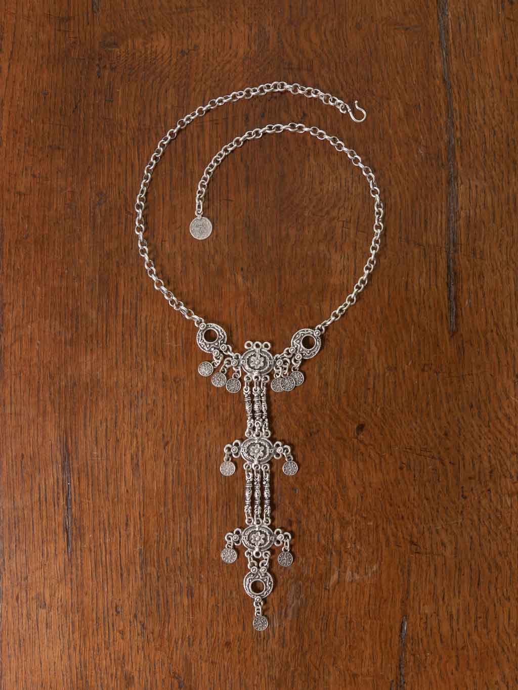 Fina Necklace - a long adjustable chain necklace with flower emblems that drape from the neckline