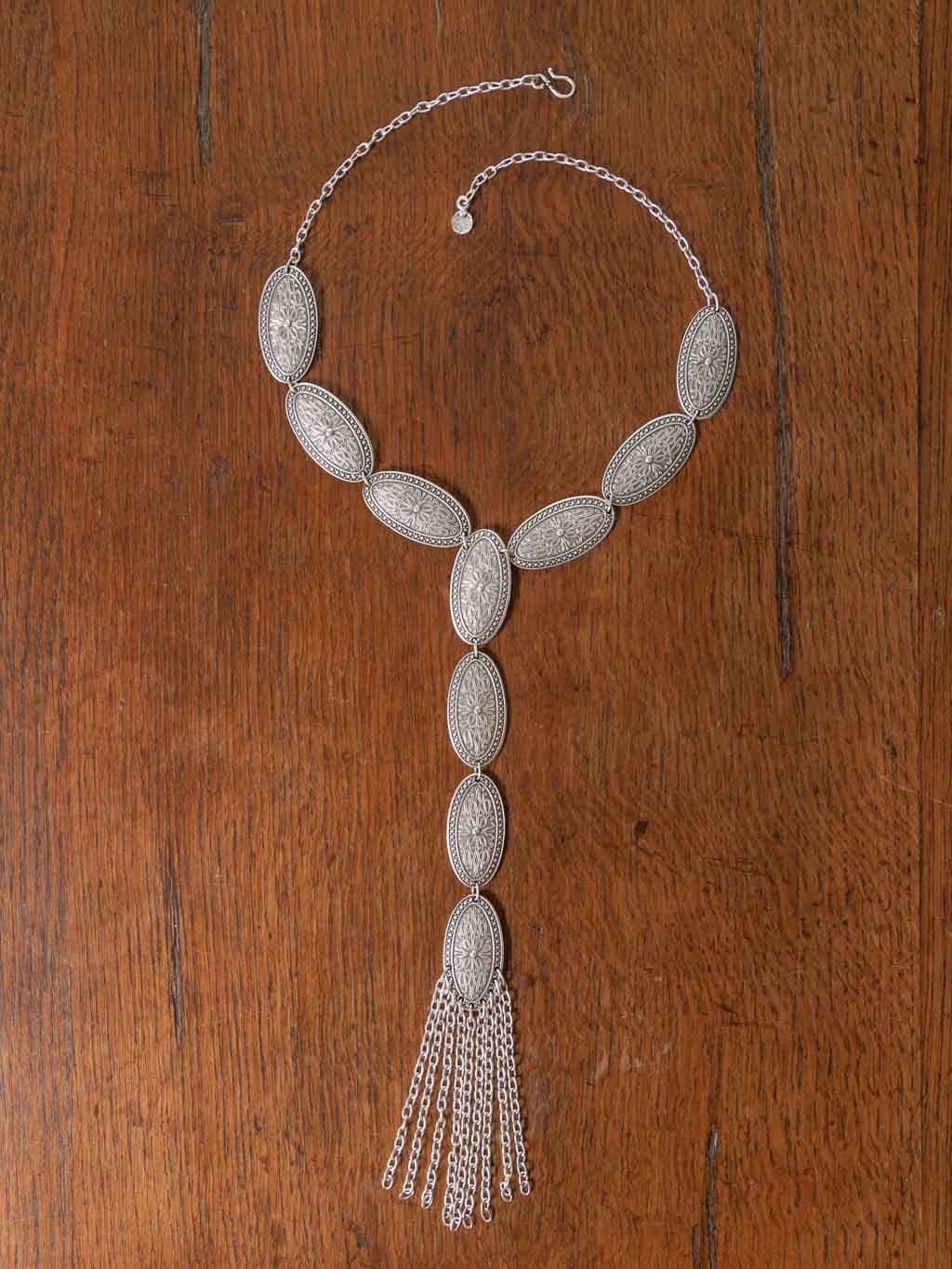 Detailed silver discs joined together to drape down the centre with silver tassels