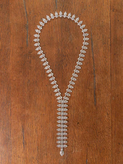 A long detailed silver tie necklace