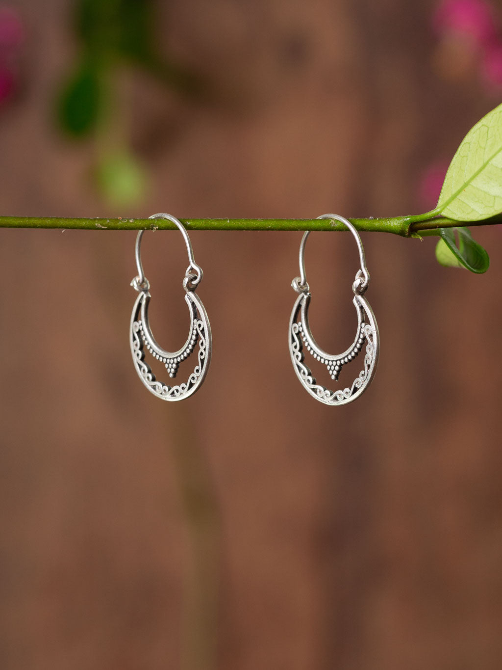 Lunar Earring - Silver clasp earring in a lacey crescent moon shape.