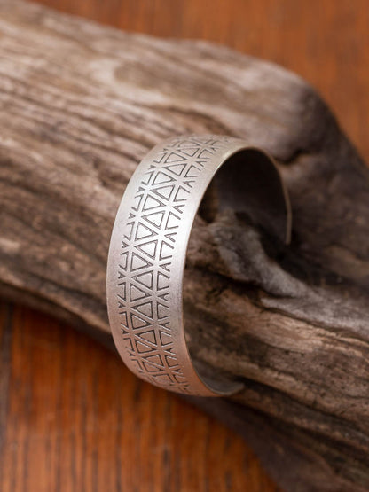 Wide silver cuff with triangle stamps