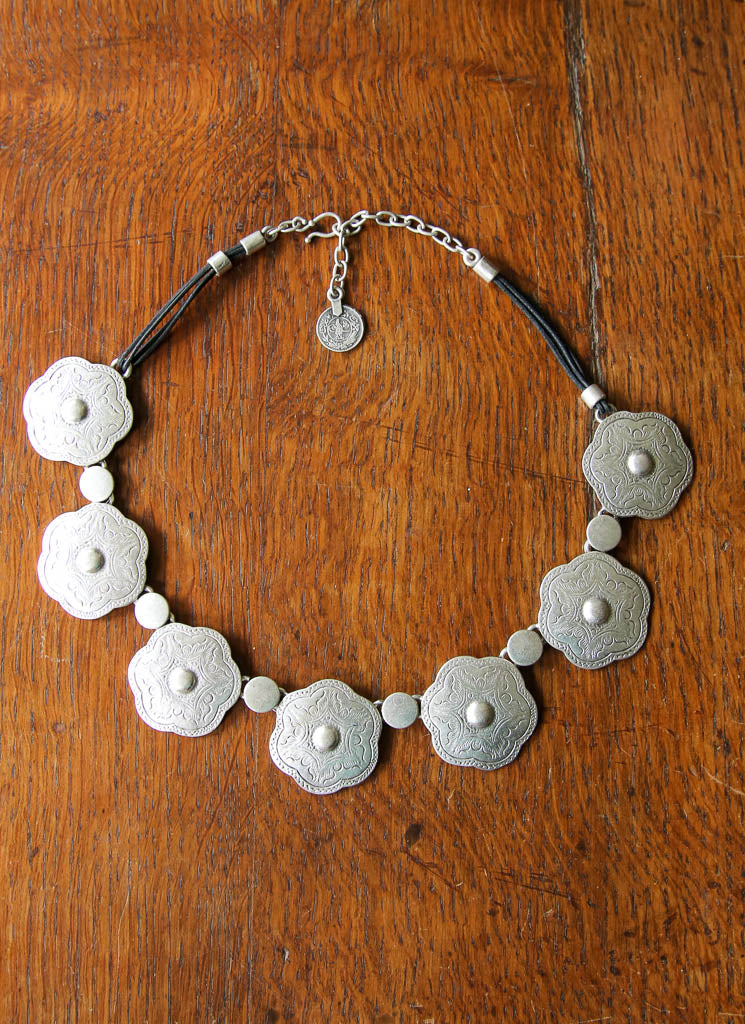 Silver concho necklace on a leather chain