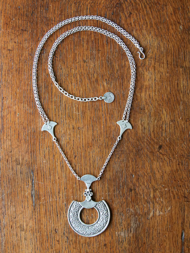 The farrow necklace is a long chain necklace with disc amulet and adjustable hook and chain closure