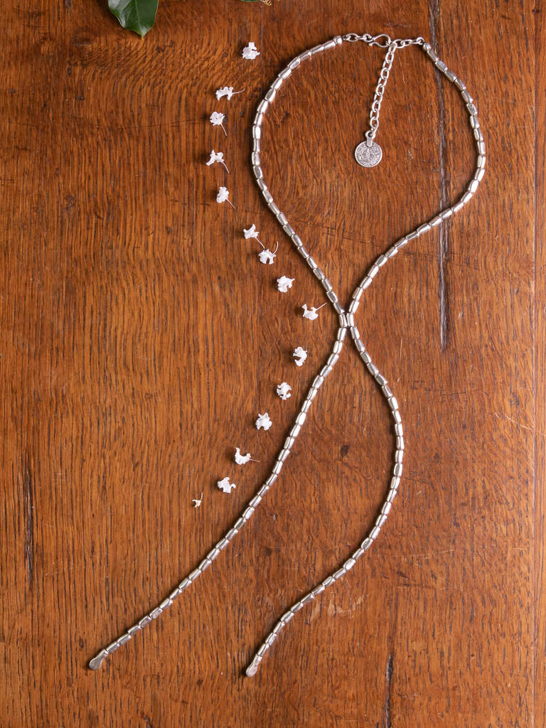 A silver chain with two silver tails