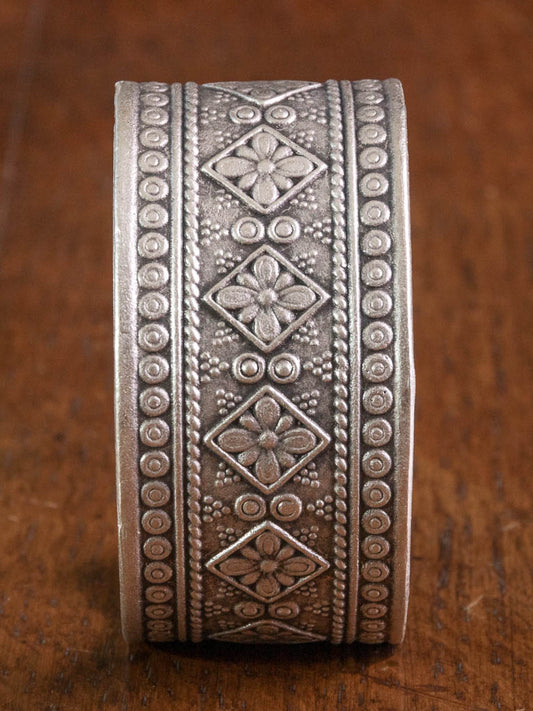 A wide cuff in silver with intricate design