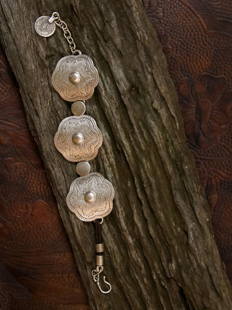 Silver concho bracelet on a leather chain