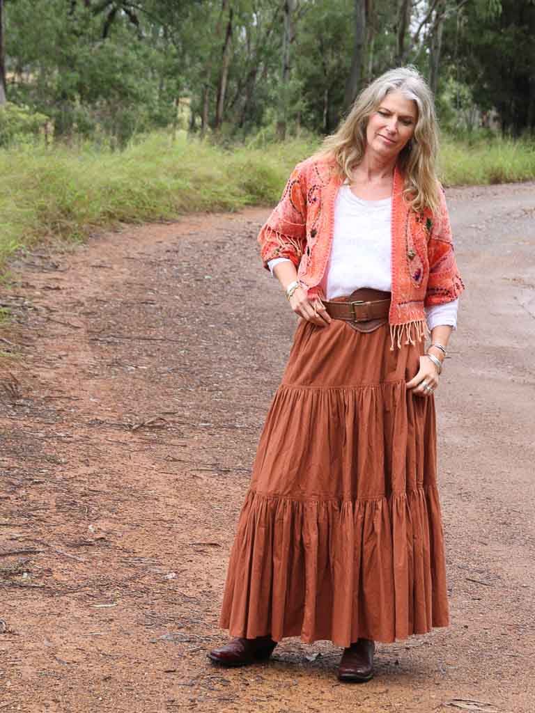 Woman wearing apricot kashmiri jacket with babushka leather belt