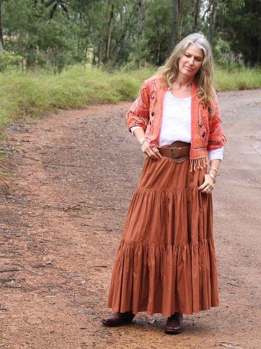 Woman wearing apricot kashmiri jacket with babushka leather belt