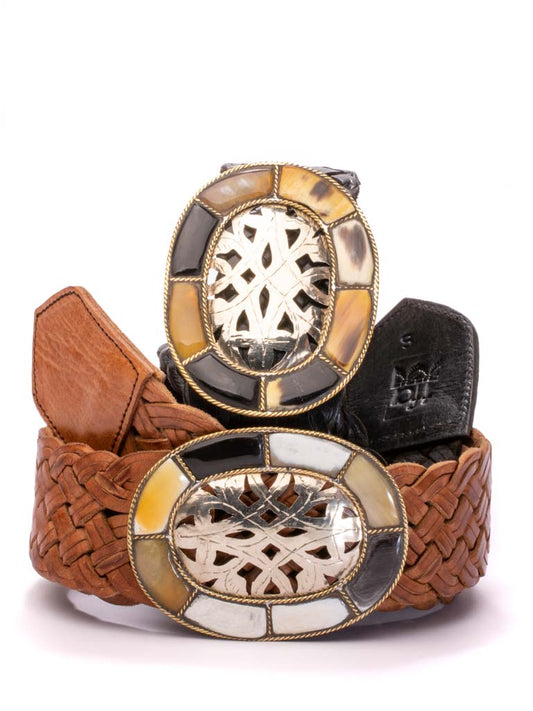 Tan and black leather belts with intricate carved buckle and bone