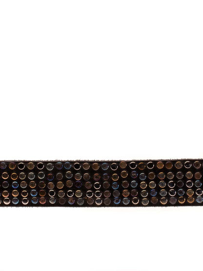 close up of leather belt covered in multi hued metal rivets 