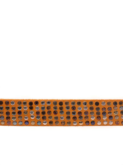 close up of leather belt covered in multi hued metal rivets 