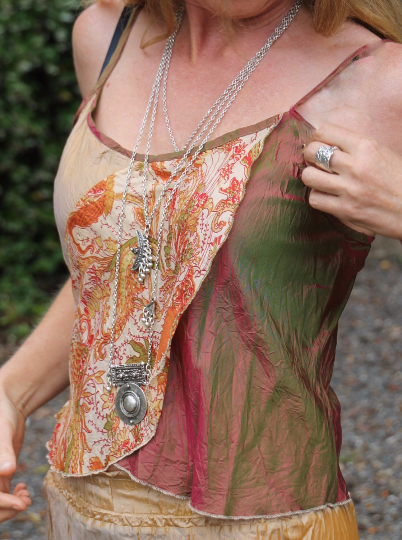 Lady wearing a caramel coloured silk cami with floral pancel