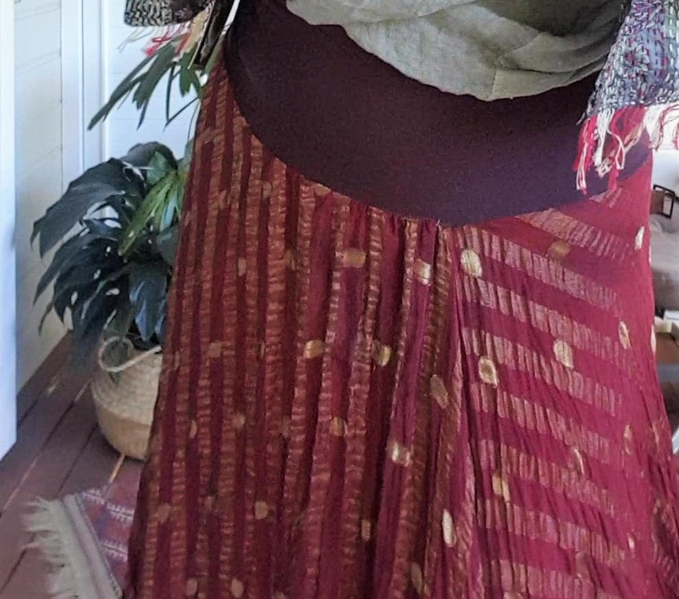 Detail of a silk sari skirt with metal thread stitching