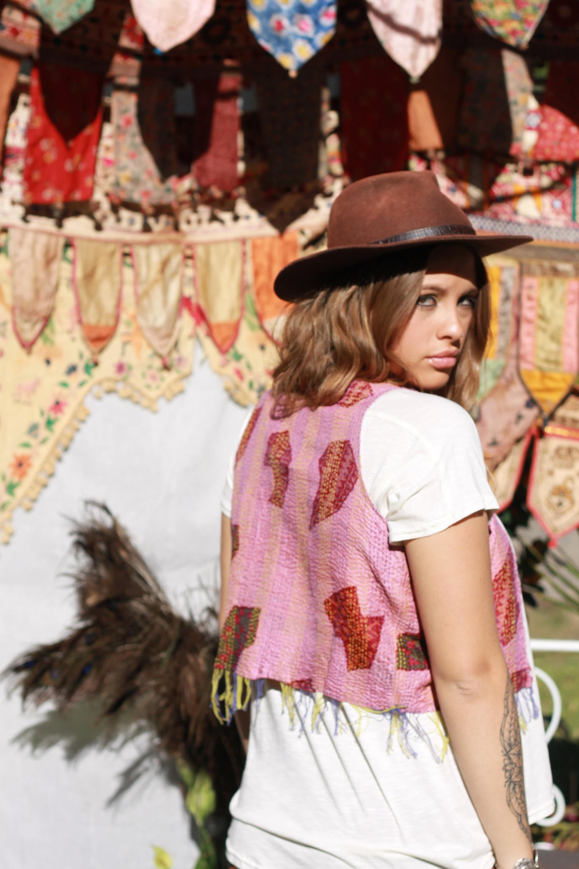 Lady showing side view of pink silk vest