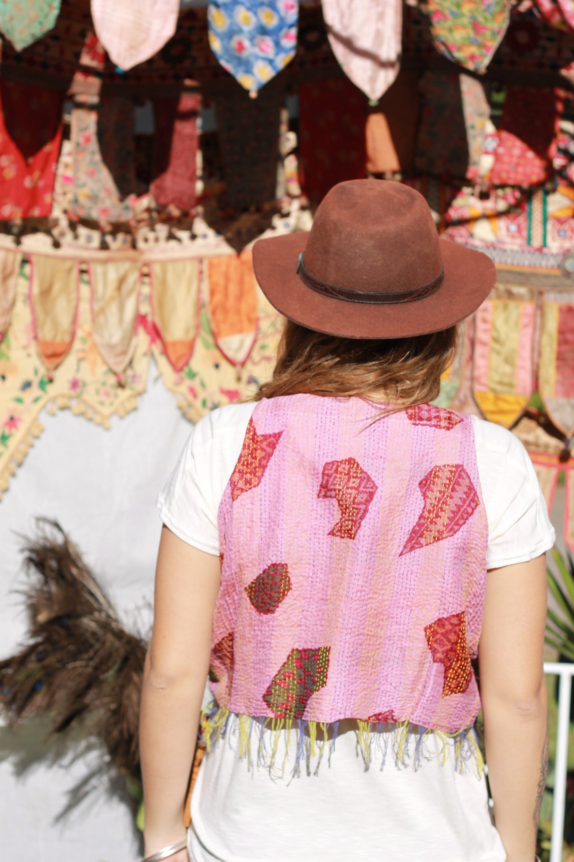 Lady wearing a hand stitched silk vest in pink pattern
