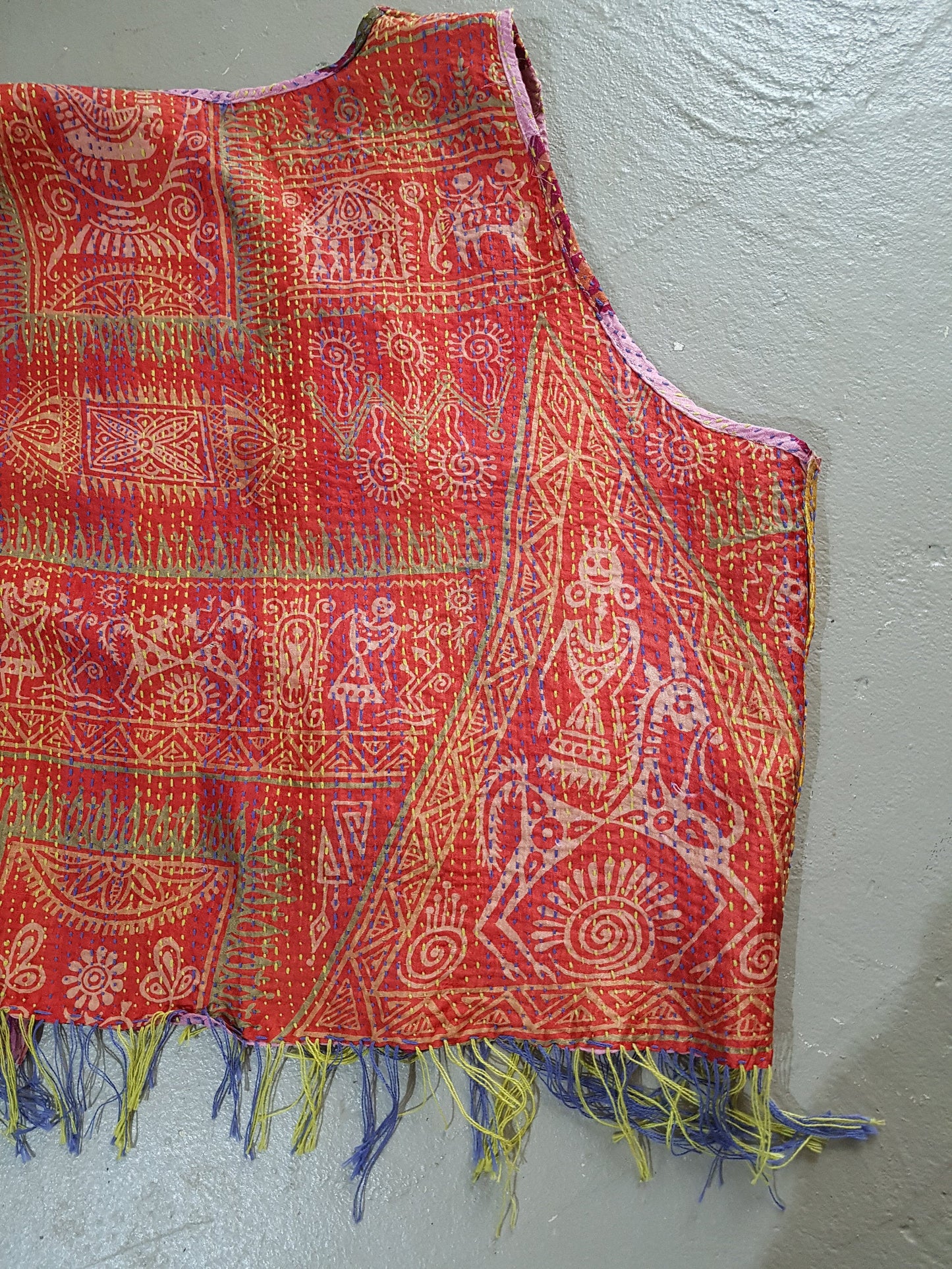 Back detail of a silk vest in red batik pattern