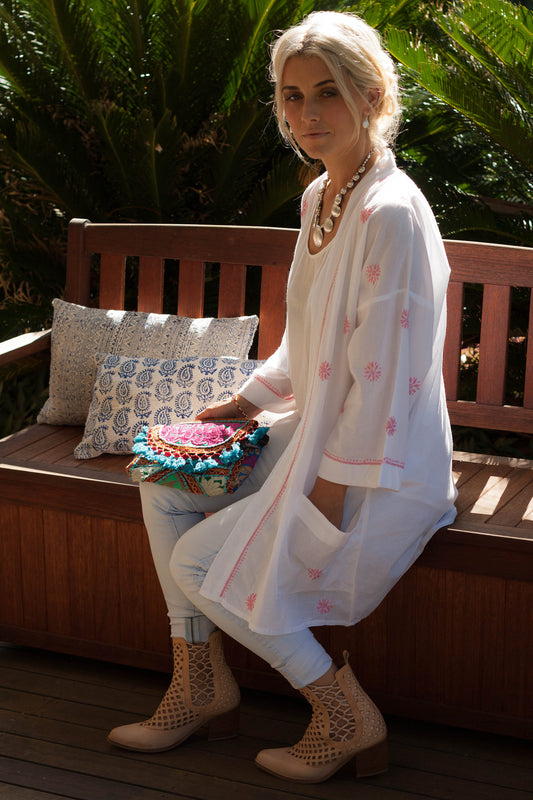 Woman wearing white cotton embroidered kimono