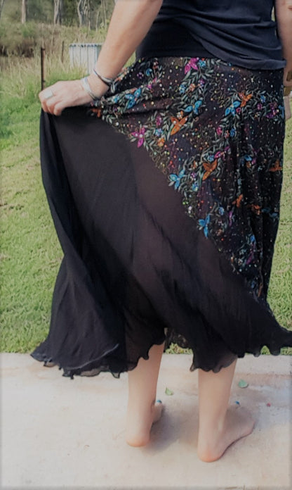 Lady showing detail of black silk sari skirt