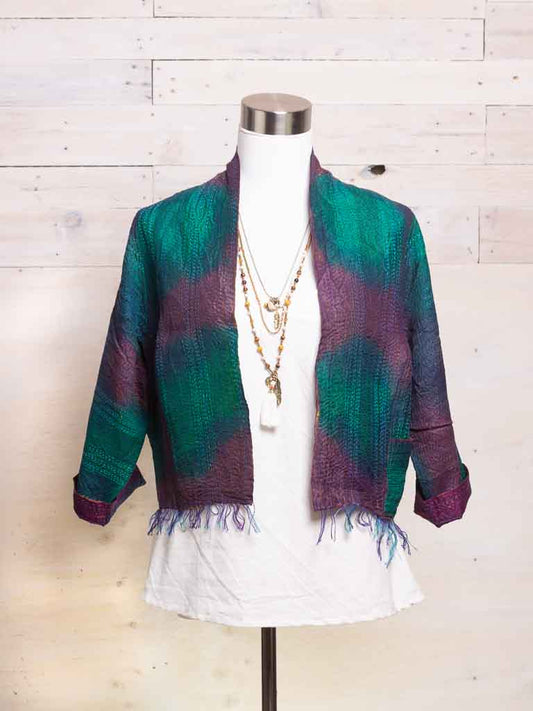 A tie dye jacket in purple green and blue tones