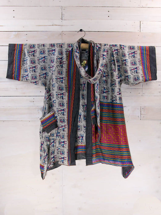 wool kimono styled jacket with figurative pattern on light background.