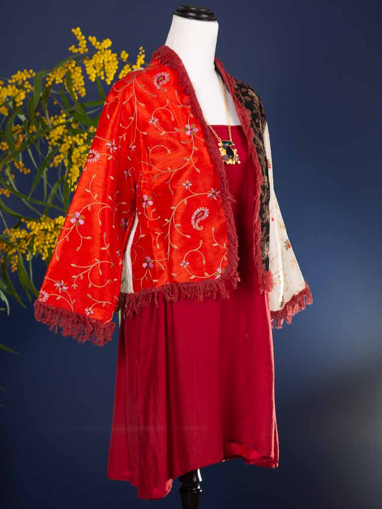 Vivid tangerine with contrast colours in ivory and black make this a standout garment