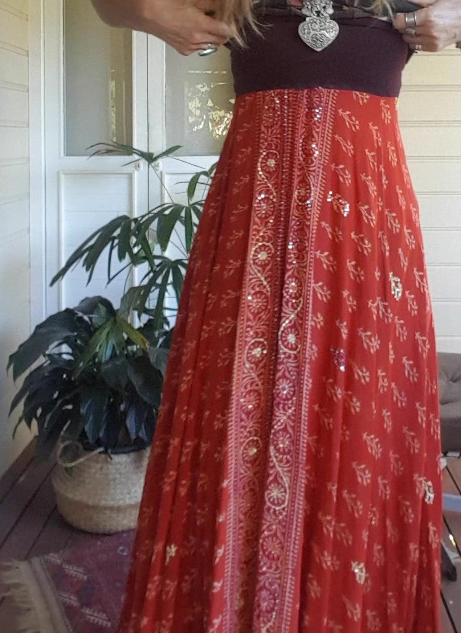 Orange skirt shown worn as a dress with wide band