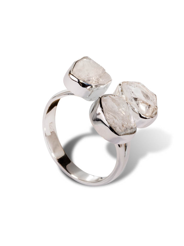 A silver ring set with clear quartz crystals
