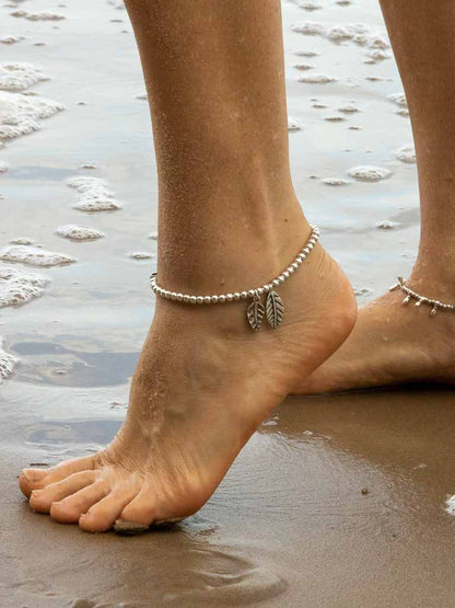 Carly Anklet - a silver ball chain with feather charms and adjustable chain link