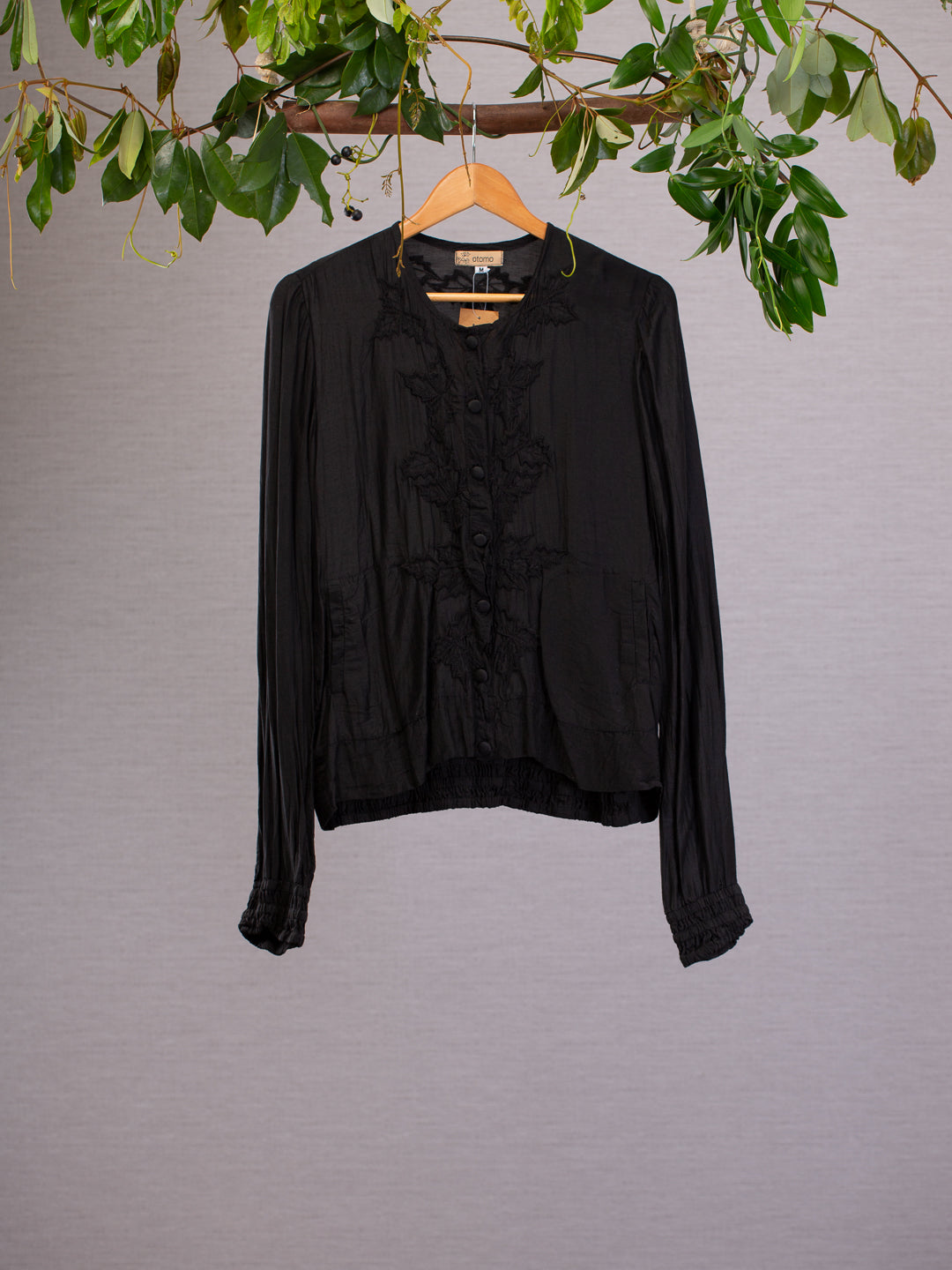 This light weight black silk jacket is subtlety embroidered around the fabric covered buttons. The comfortable fit is finished with an elasticised waist and cuffs, and also boasts with practical pockets.
