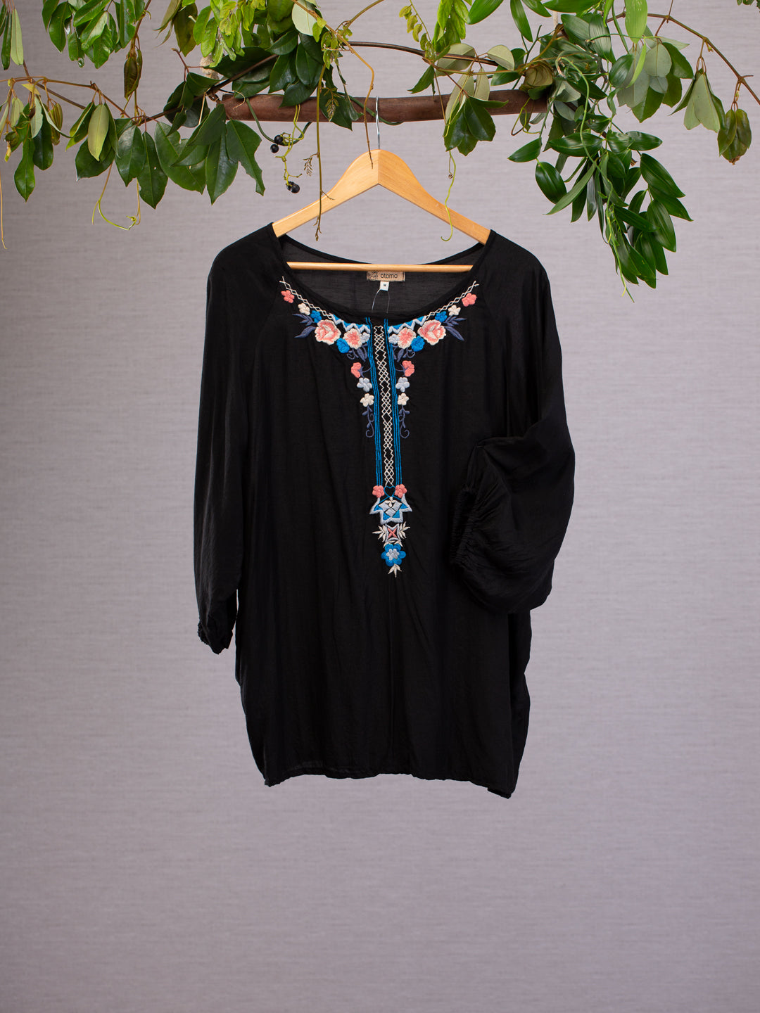 Black silk linen blend top Top features bold embroidered patterns around its neckline, the black silk linen blend is gathered with elastic at the cuff and styled in a flowing generous fit.