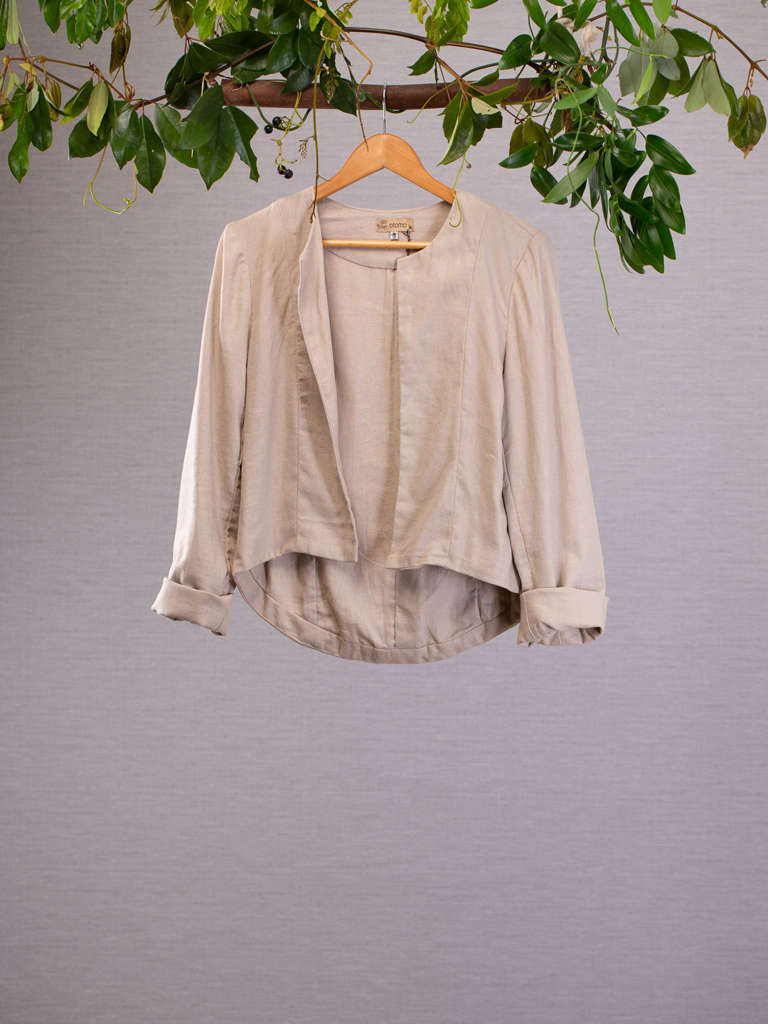 Refine your style with this tailored Otomo jacket, Made in 100% Linen the designer panelling gives this cream jacket a minimalist look. Cream jacket hanging from vines with it's sleeves rolled up.