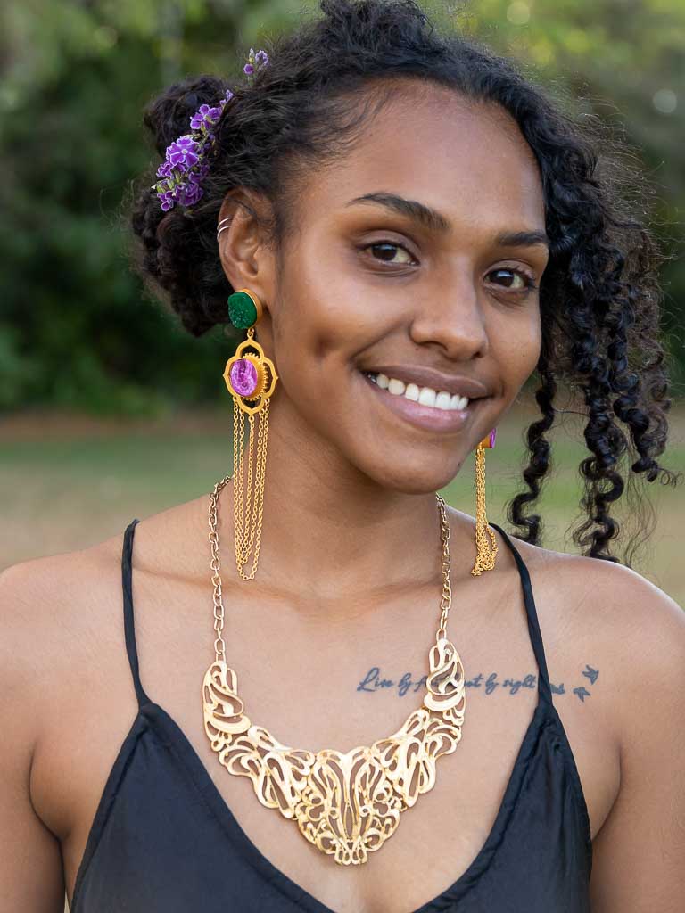 Woman wearing gold lacework necklace