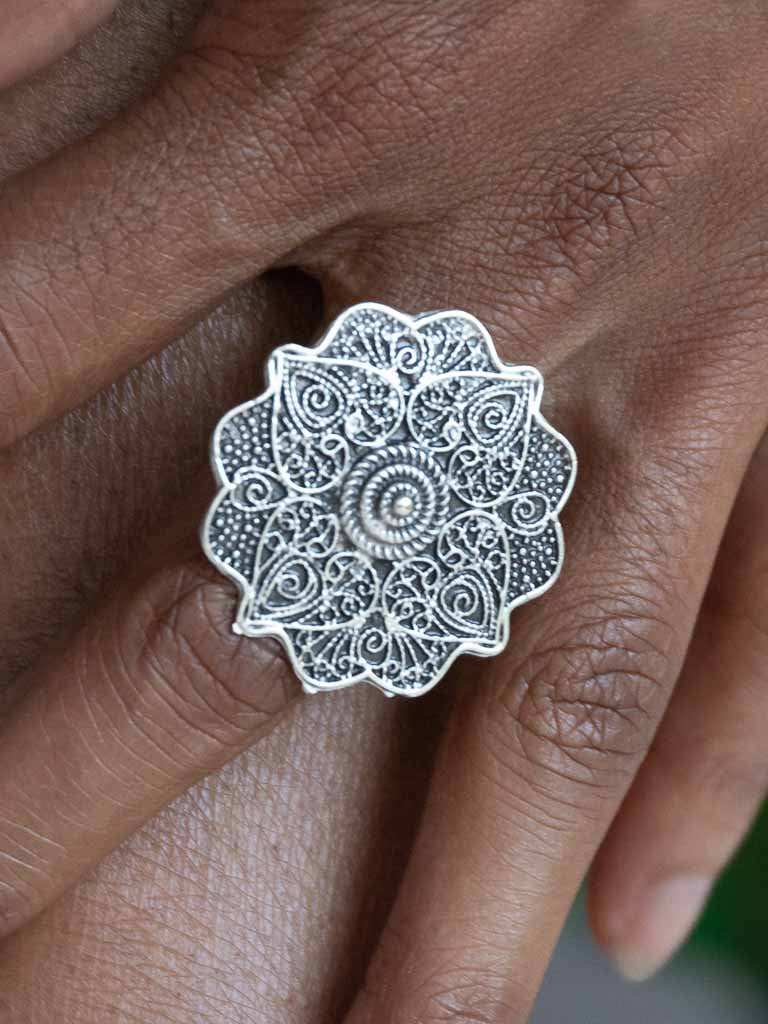 A large round detailed silver ring