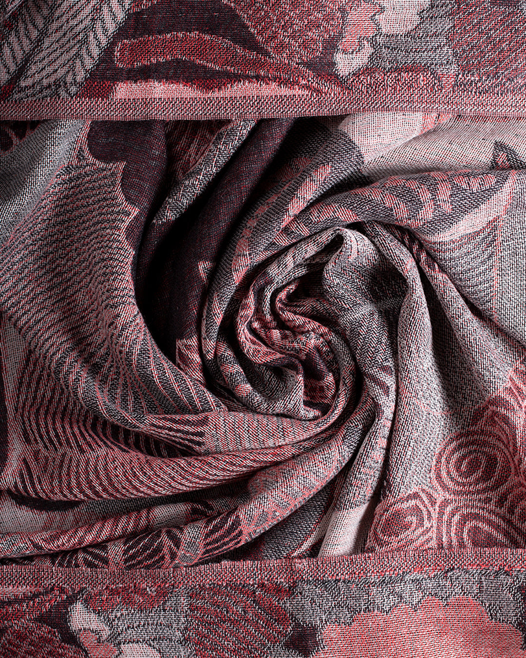 Wine and grey abstract jungle pattern scarf twisted into a swirl as flat lay.