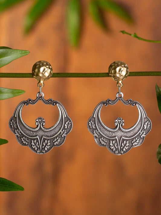 Chandra Earring Gold stud supporting a glittering silver moon like shape.