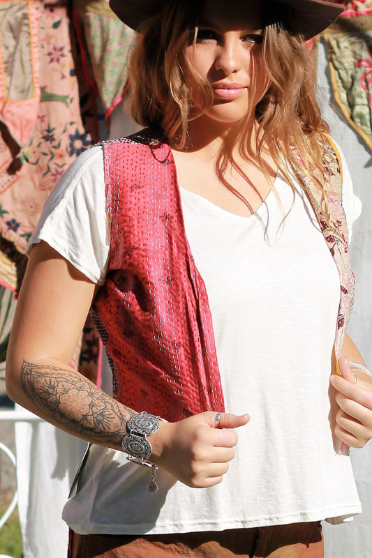 Lady wearing a hand stitch vest front view red